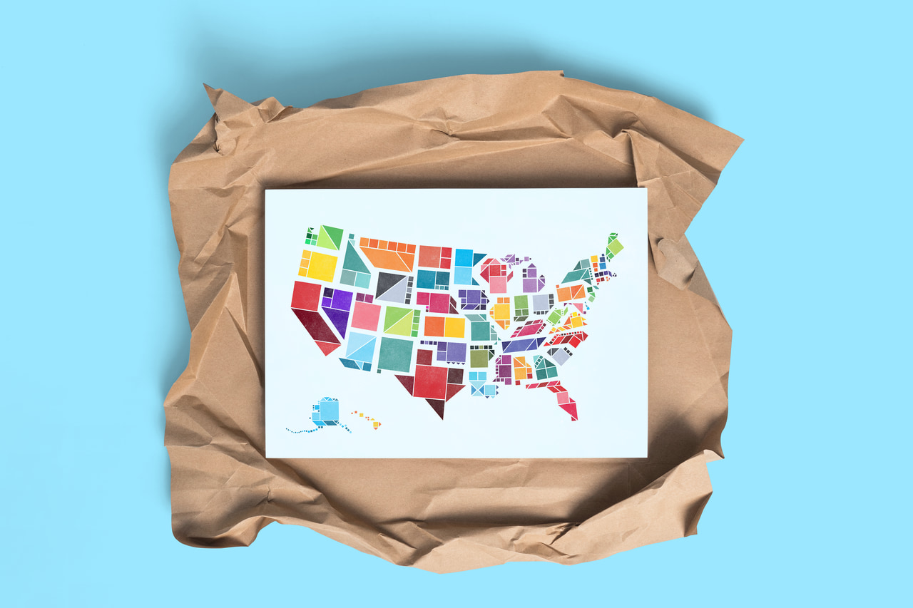 Tangram States project: colorful geometric United States map print on crumpled brown packing paper.